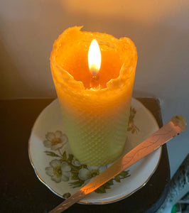 Large hand rolled beeswax pillar candle lit