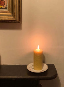 Lit handrolled beeswax candle